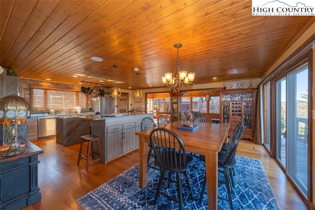 186 Woodcrest Road Glade Valley, NC 28627 - Photo 12 of 50 a view of a dining room with furniture window and wooden floor