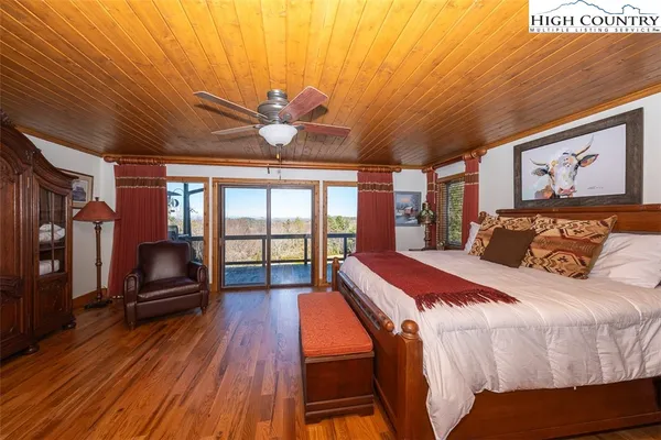 a bedroom with furniture and wooden floor