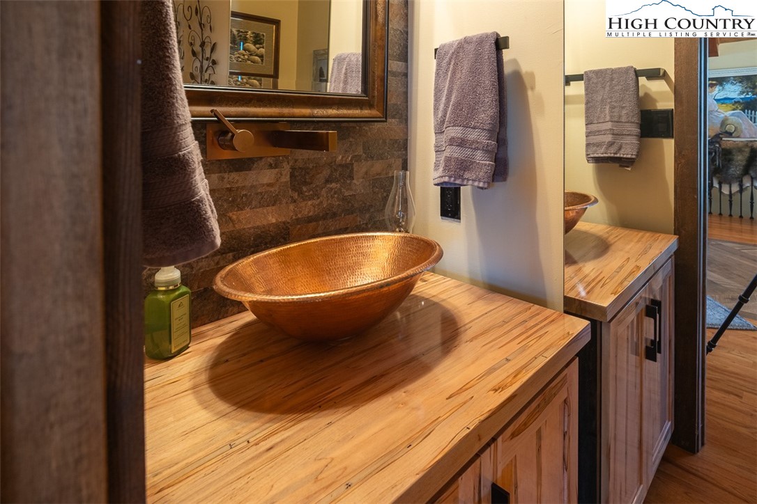186 Woodcrest Road Glade Valley, NC 28627 - Photo 23 of 50 a bathroom with a sink and mirror