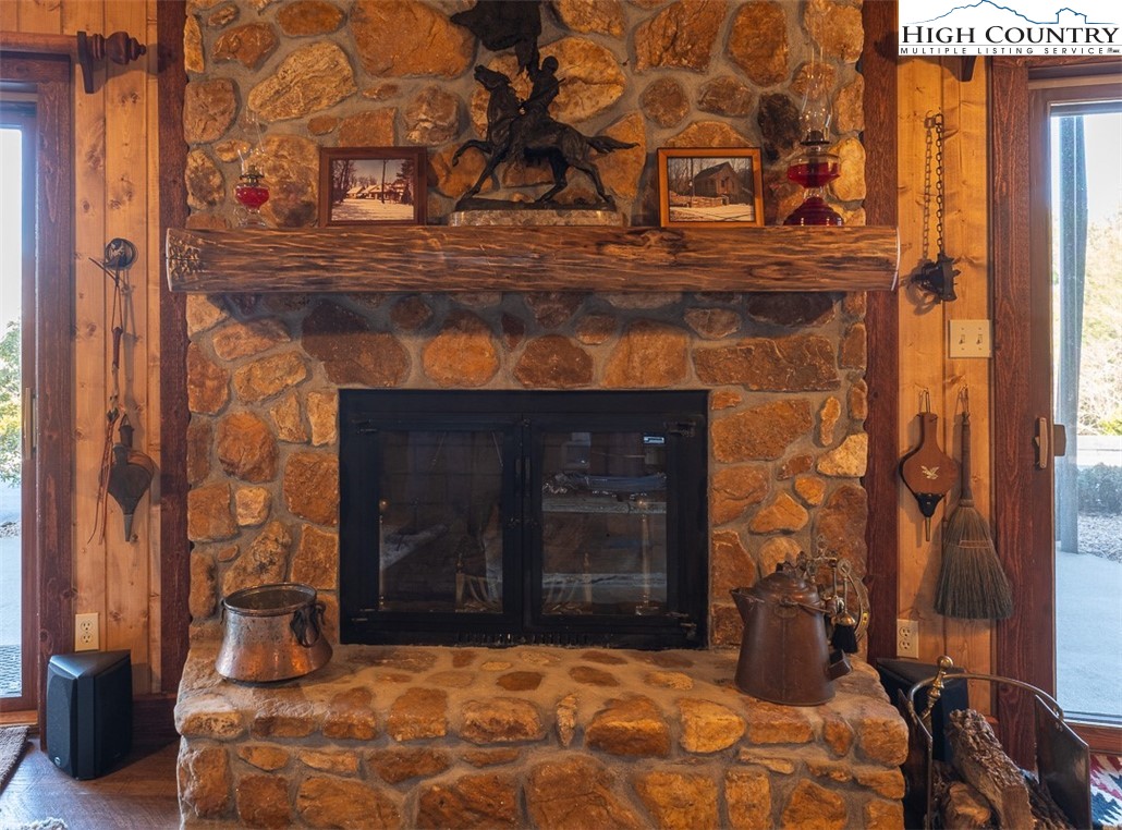 186 Woodcrest Road Glade Valley, NC 28627 - Photo 25 of 50 a bedroom with a bed and a fireplace
