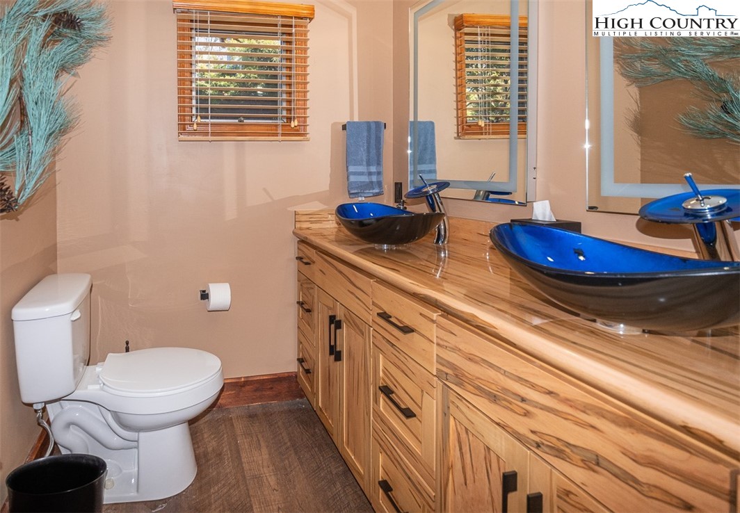 186 Woodcrest Road Glade Valley, NC 28627 - Photo 30 of 50 a bathroom with a toilet sink and mirror