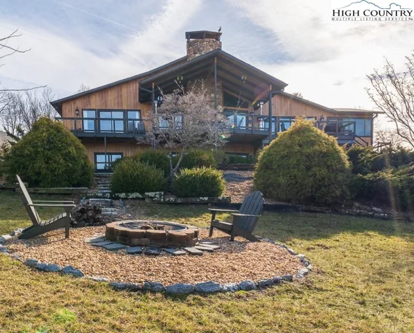 a view of a house with backyard water fountain and sitting area