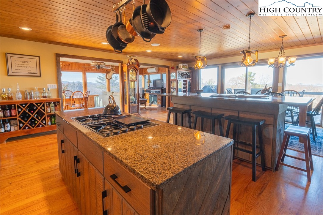 186 Woodcrest Road Glade Valley, NC 28627 - Photo 9 of 50 a kitchen with stainless steel appliances granite countertop a stove a sink and a wooden cabinets