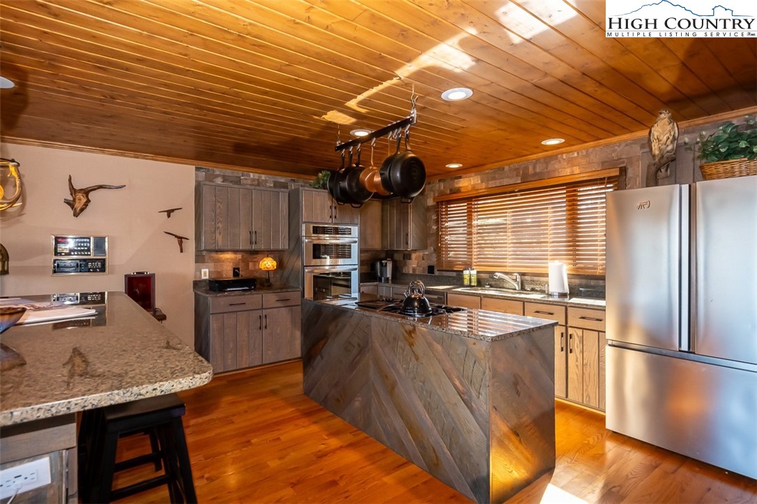186 Woodcrest Road Glade Valley, NC 28627 - Photo 10 of 50 a kitchen with stainless steel appliances granite countertop a sink stove and refrigerator