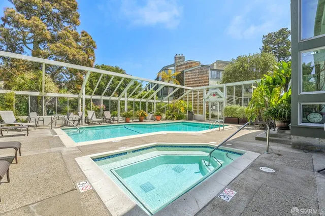 a view of a tennis ground with large buildings