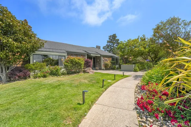 a front view of a house with garden
