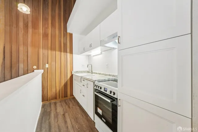 a kitchen with stainless steel appliances granite countertop a stove and a refrigerator