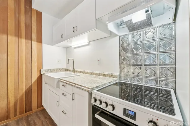 a view of a kitchen with a sink and wooden floor