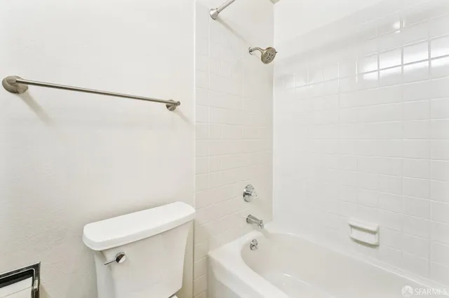 a bathroom with a bathtub and a toilet