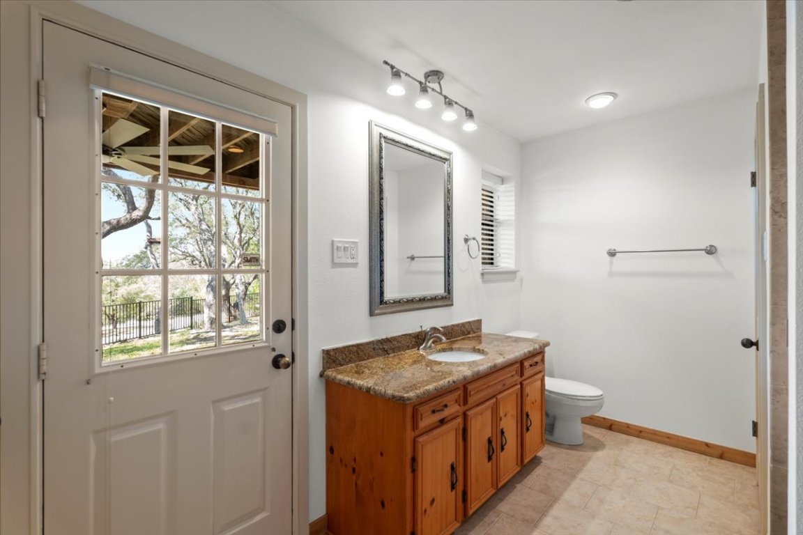 16808 Forest Way Austin, TX 78734 - Photo 25 of 33 a bathroom with a sink and a mirror
