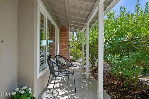 a view of a patio with table and chairs and potted plants