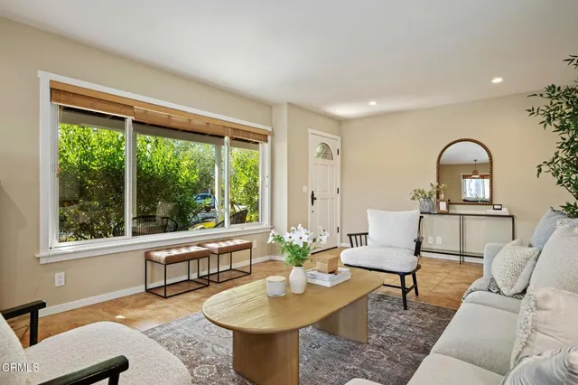 a living room with furniture and a large window