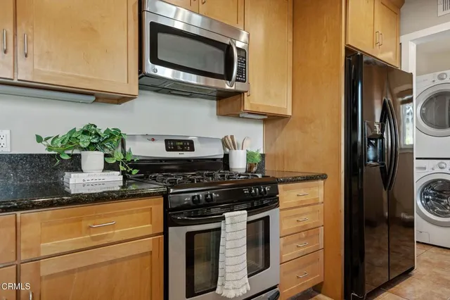 a kitchen with stainless steel appliances a stove a microwave and cabinets