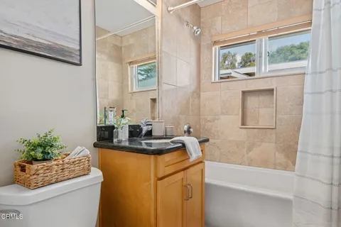 a bathroom with a sink a bathtub and a window