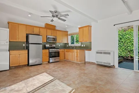 a kitchen with a refrigerator and a stove
