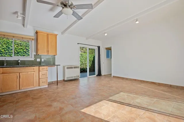 a view of a kitchen with a sink and cabinets