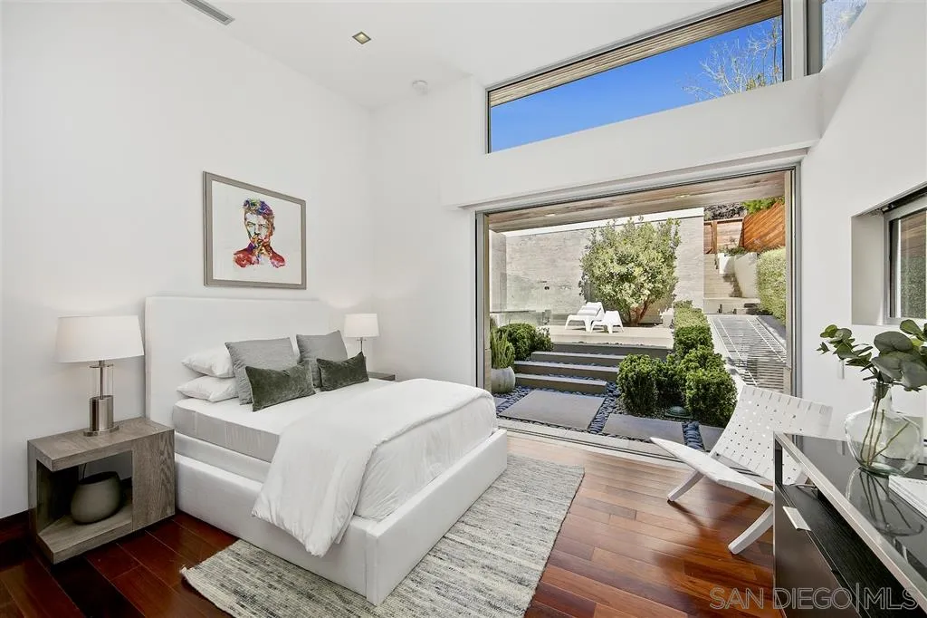 116 Nob Avenue Del Mar, CA 92014 - Photo 12 of 25 a bedroom with a large white bed a large window with garden view