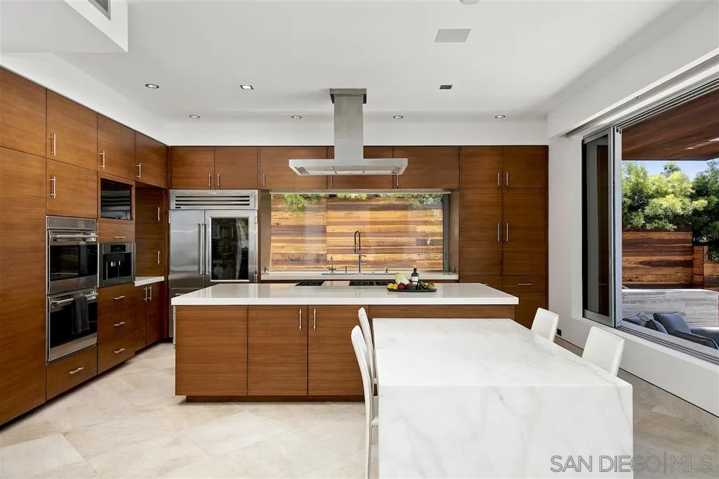 116 Nob Avenue Del Mar, CA 92014 - Photo 6 of 25 a kitchen with kitchen island a stove a sink and a refrigerator