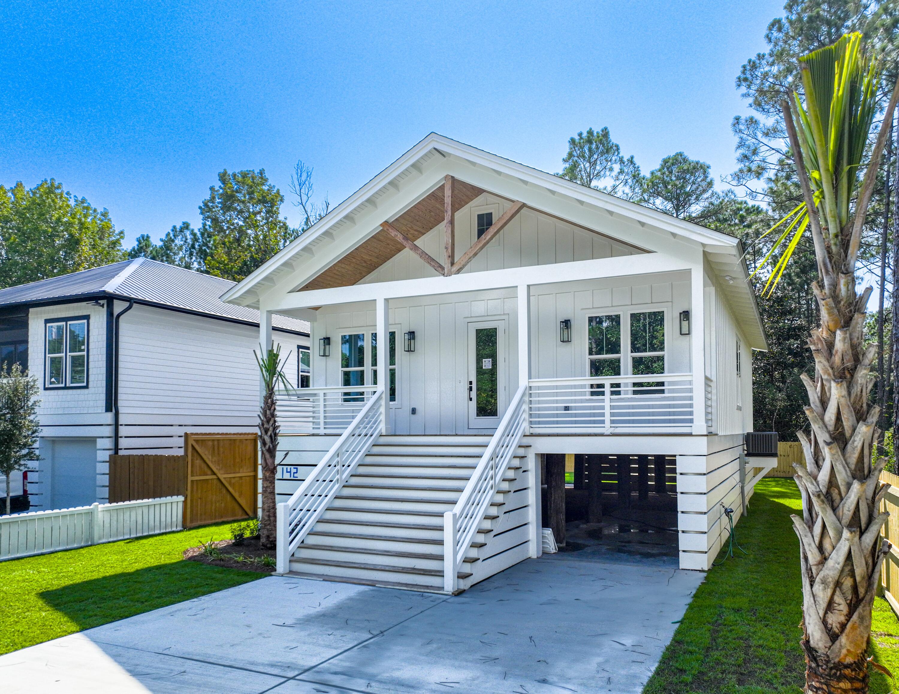 142 7th Street Santa Rosa Beach, FL 32459 - Photo 1 of 22 a front view of a house with a yard