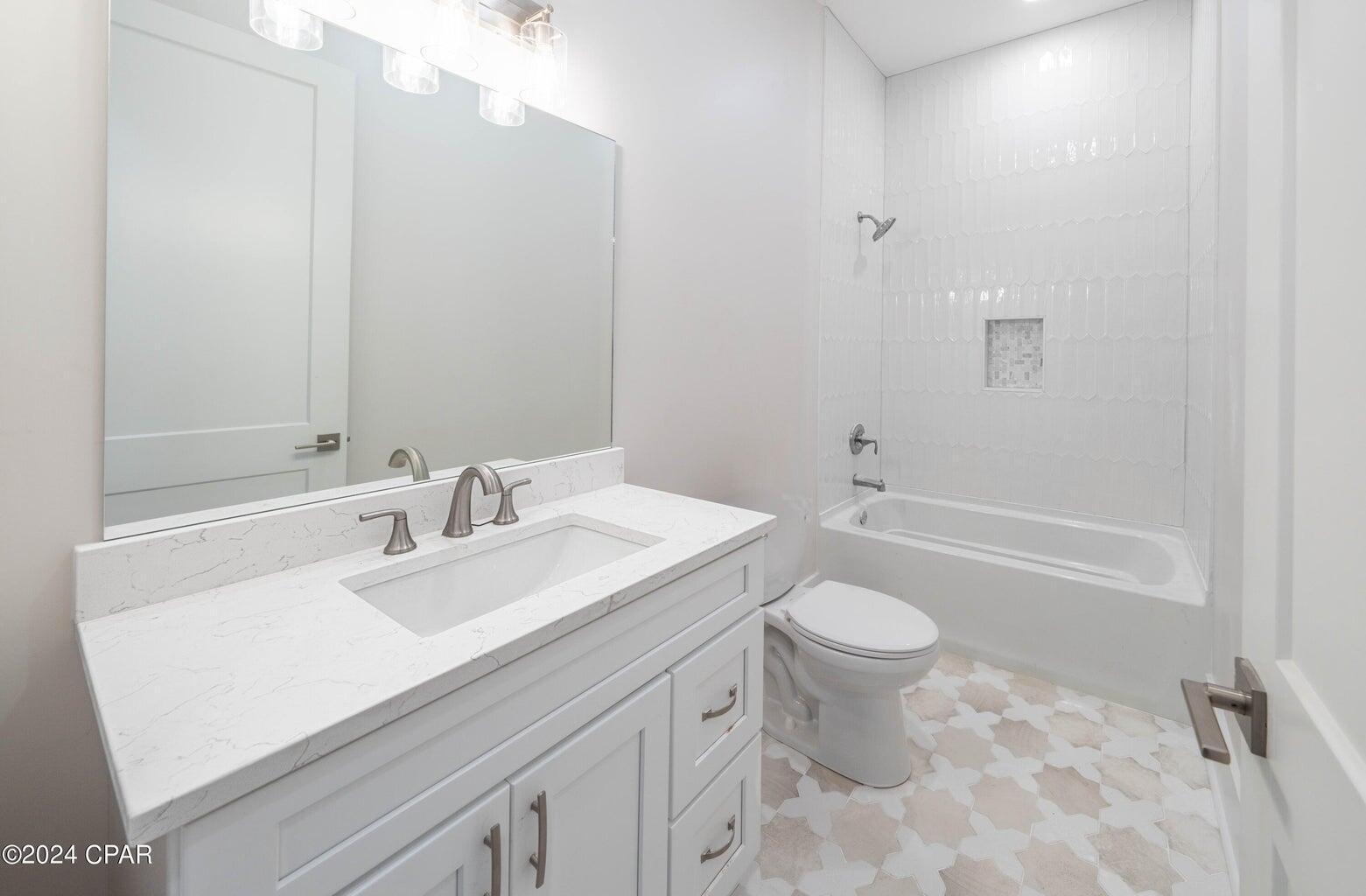 142 7th Street Santa Rosa Beach, FL 32459 - Photo 13 of 22 a bathroom with a sink a toilet and shower