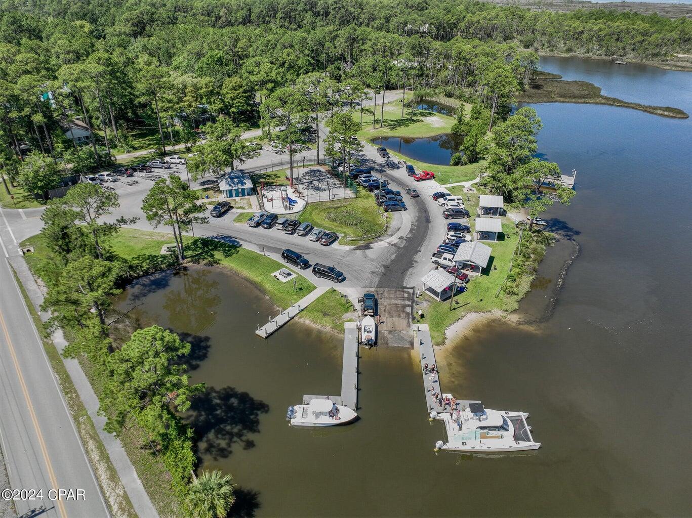 142 7th Street Santa Rosa Beach, FL 32459 - Photo 20 of 22 an aerial view of a house with a yard and lake view