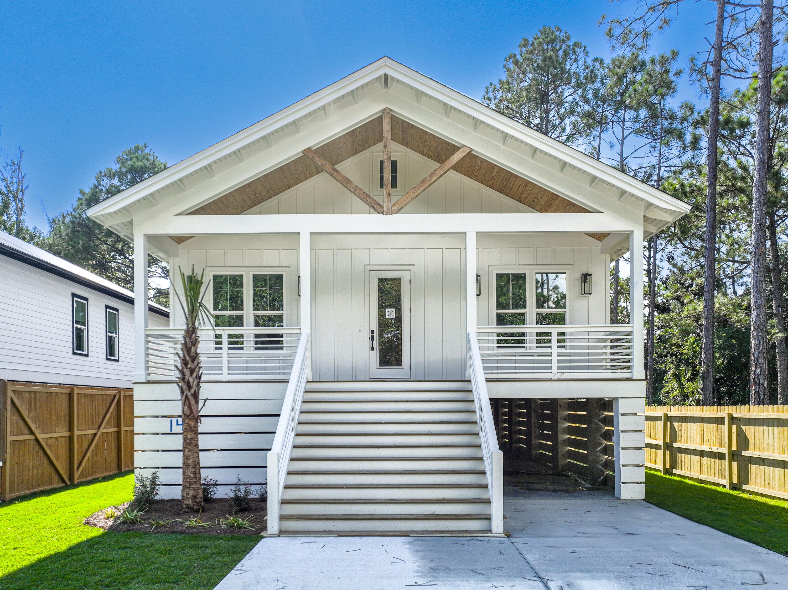 142 7th Street Santa Rosa Beach, FL 32459 - Photo 2 of 22 a front view of a house with a yard