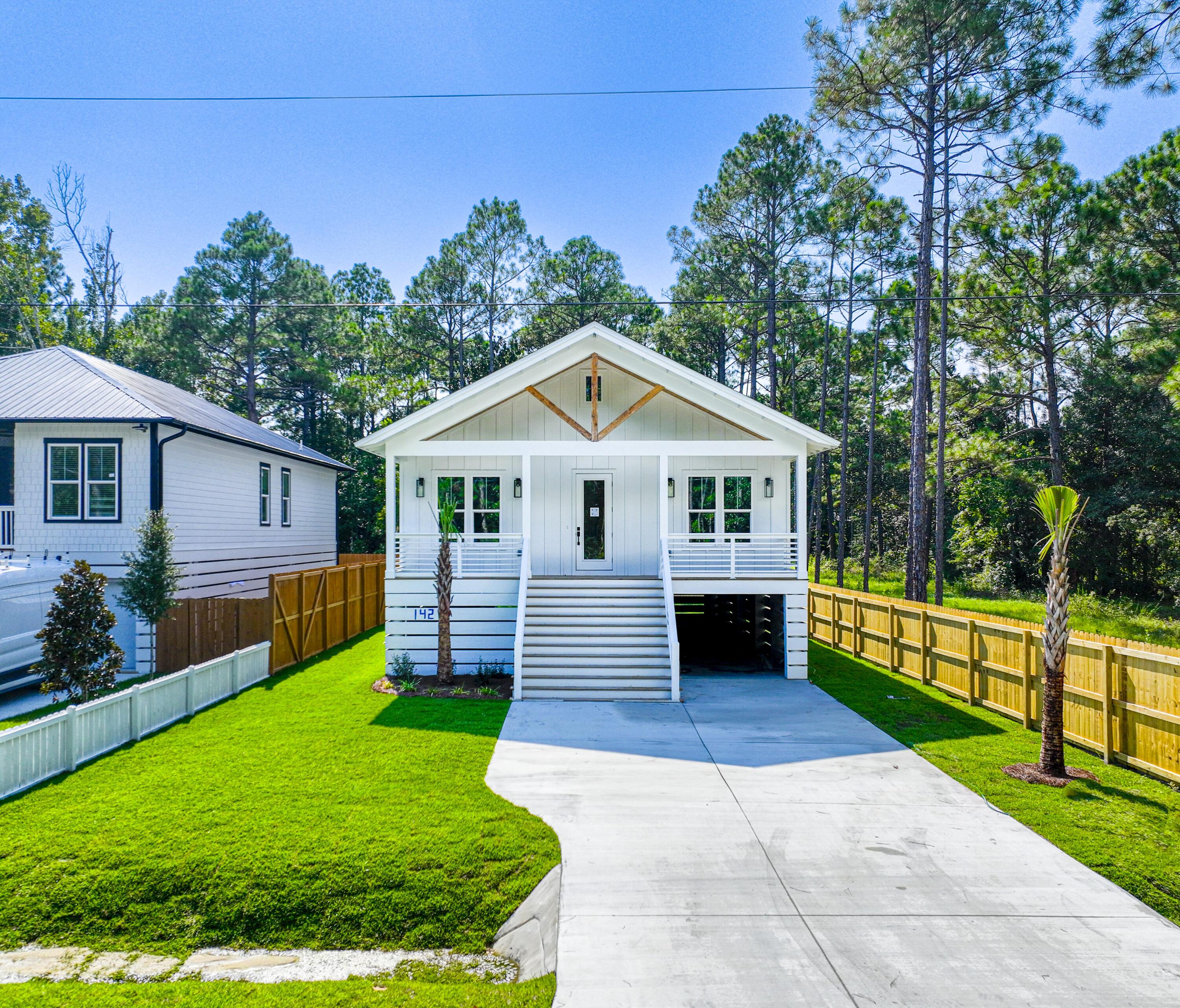142 7th Street Santa Rosa Beach, FL 32459 - Photo 3 of 22 a front view of a house with garden