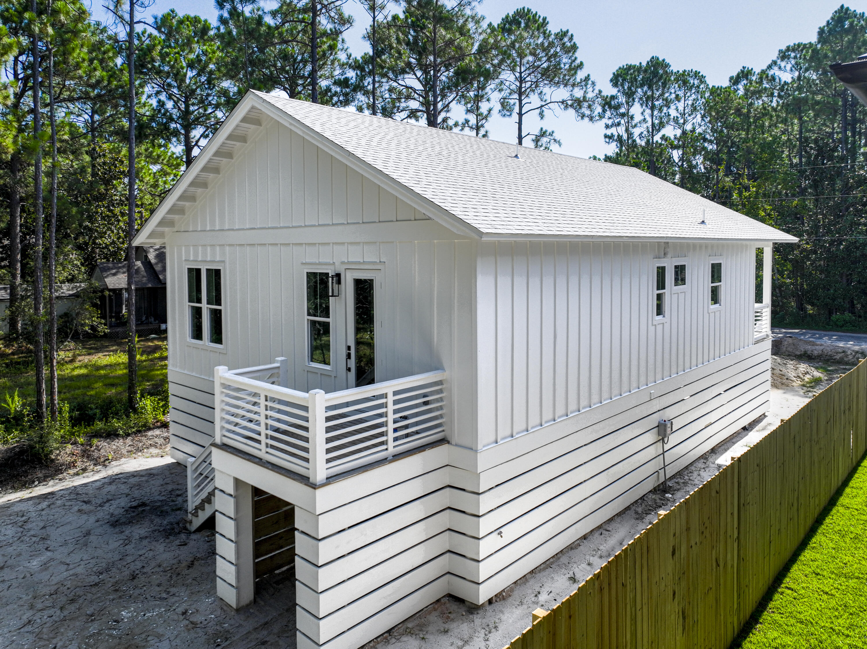 142 7th Street Santa Rosa Beach, FL 32459 - Photo 4 of 22 a view of a white house in front of a house