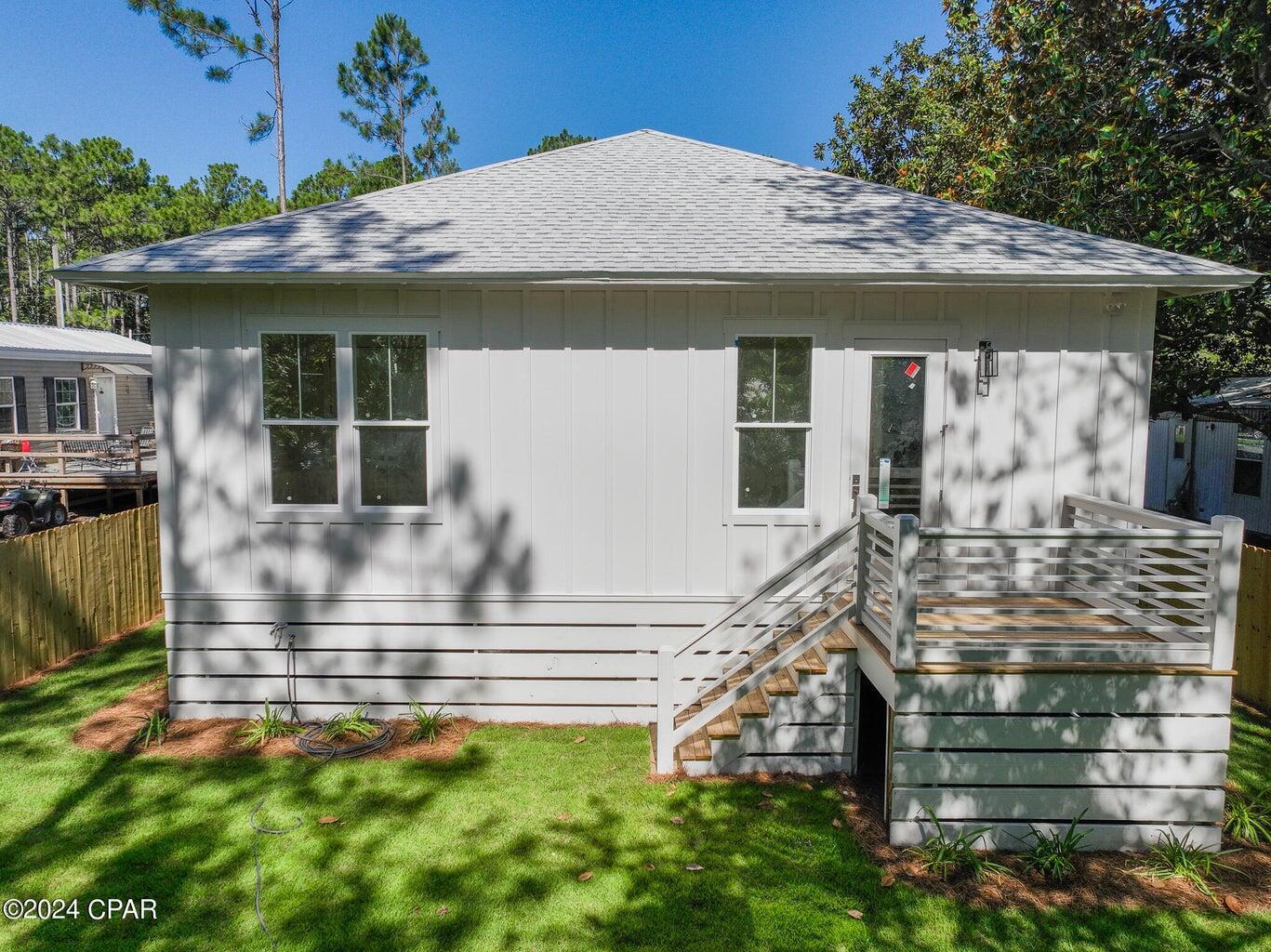 142 7th Street Santa Rosa Beach, FL 32459 - Photo 5 of 22 a front view of a house with a garden