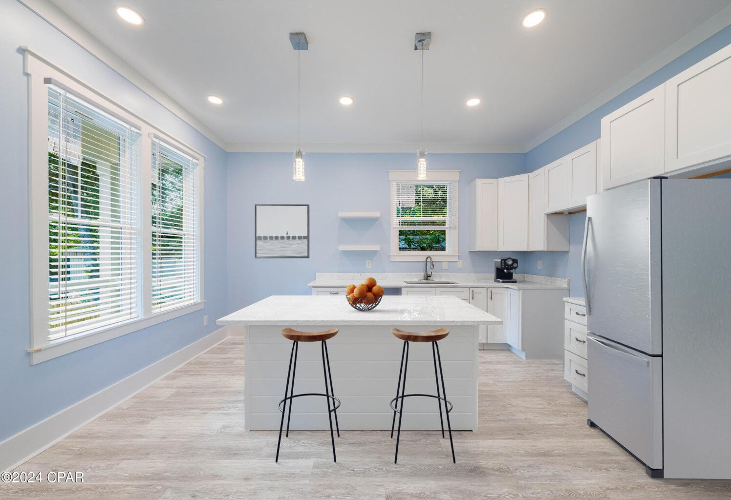 142 7th Street Santa Rosa Beach, FL 32459 - Photo 8 of 22 a kitchen with stainless steel appliances kitchen island granite countertop a table chairs sink and cabinets