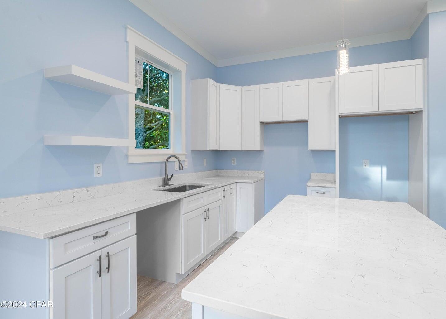 142 7th Street Santa Rosa Beach, FL 32459 - Photo 9 of 22 a kitchen with a sink cabinets and window