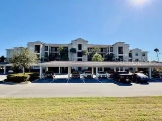 a front view of a building with cars parked