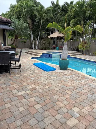 a swimming pool with outdoor seating