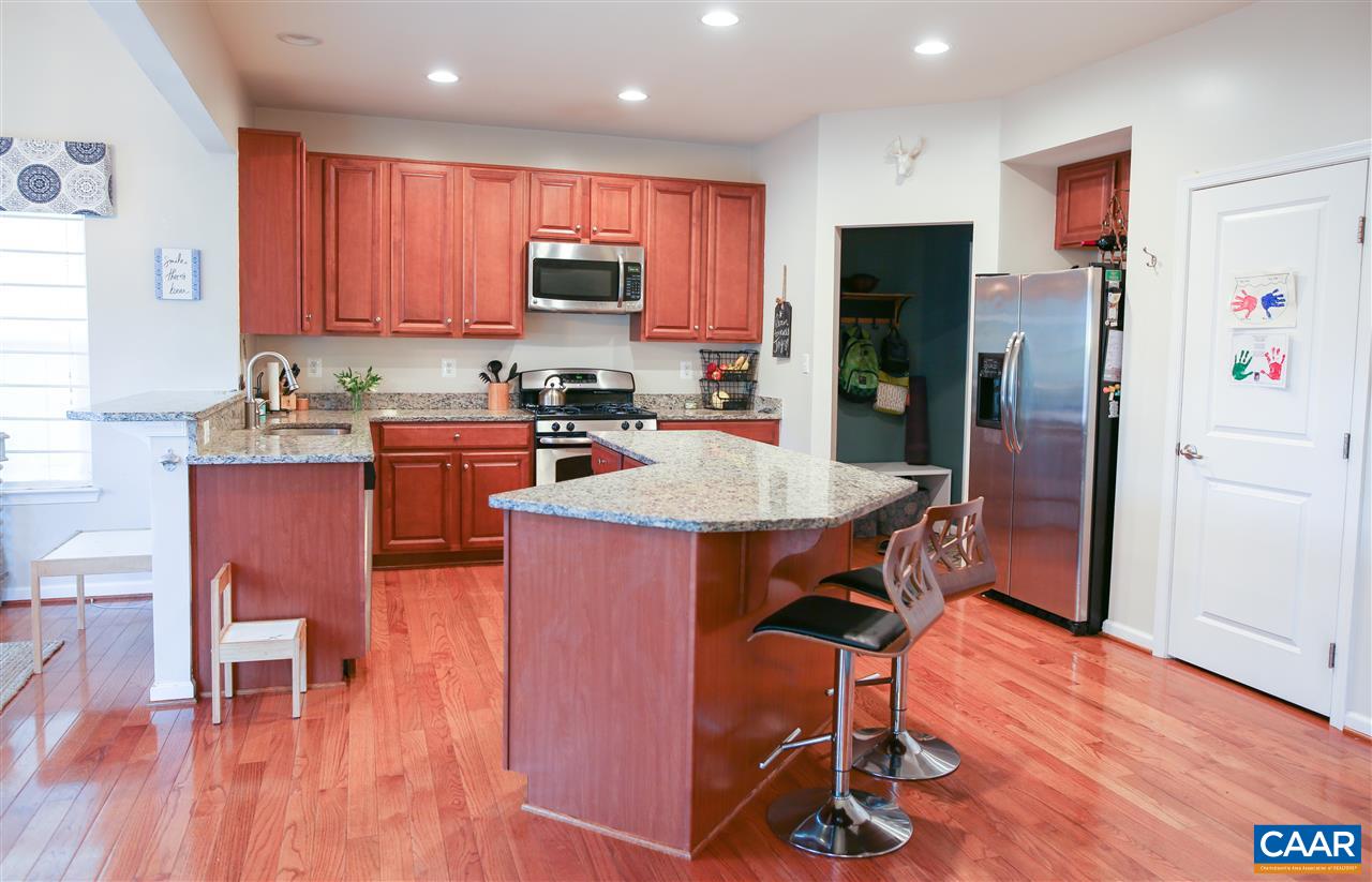 5586 Summerdean Road Crozet, VA 22932 - Photo 3 of 13 a kitchen with stainless steel appliances granite countertop a refrigerator a stove top oven a sink dishwasher and wooden floor
