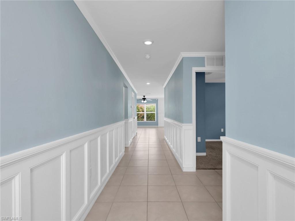 731 Hadley Place West Naples, FL 34104 - Photo 2 of 30 Foyer and Entry Hallway With Crown Molding and Wainscotting