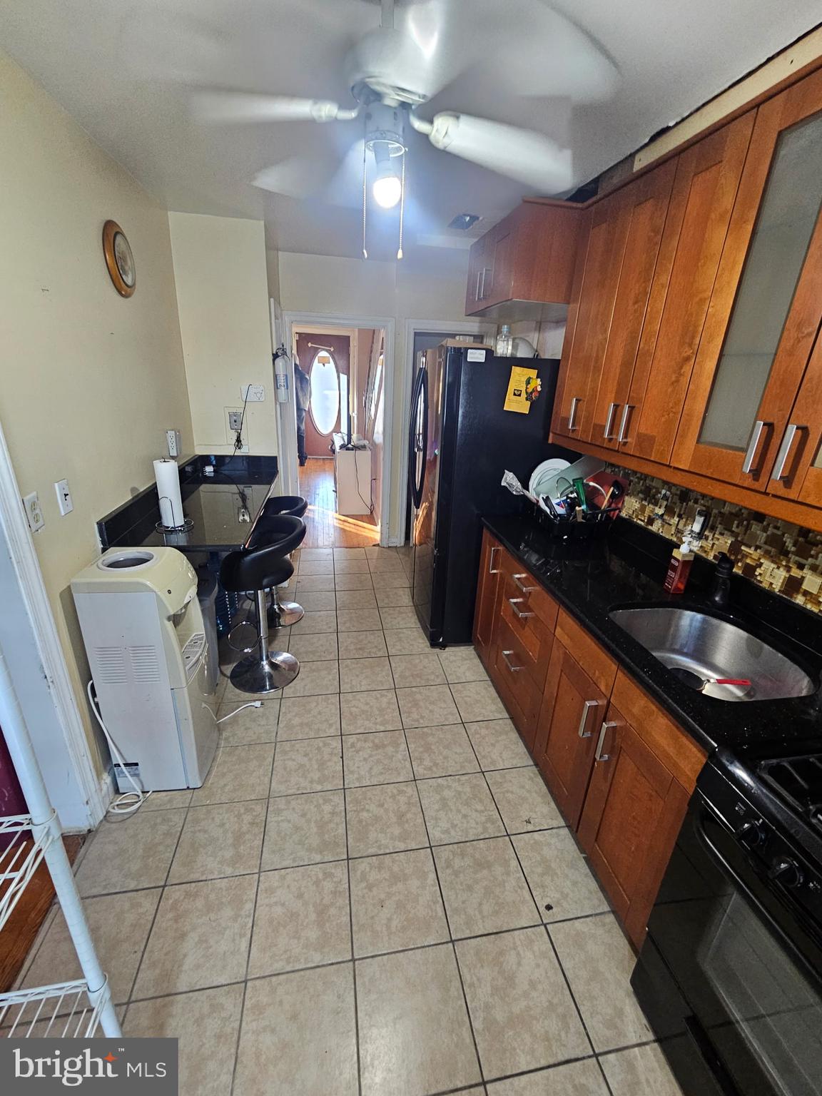 3915 Ednor Road Baltimore, MD 21218 - Photo 6 of 10 a kitchen with granite countertop a stove a sink and a counter top space