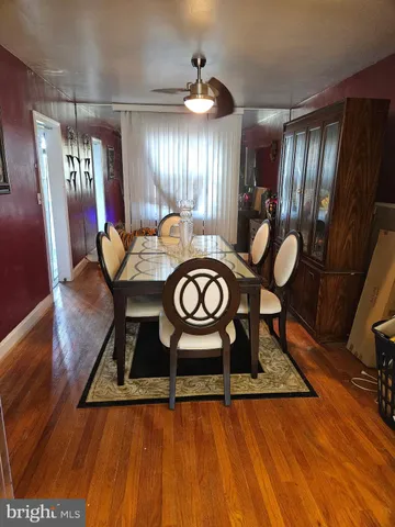 a view of a room with furniture and wooden floor