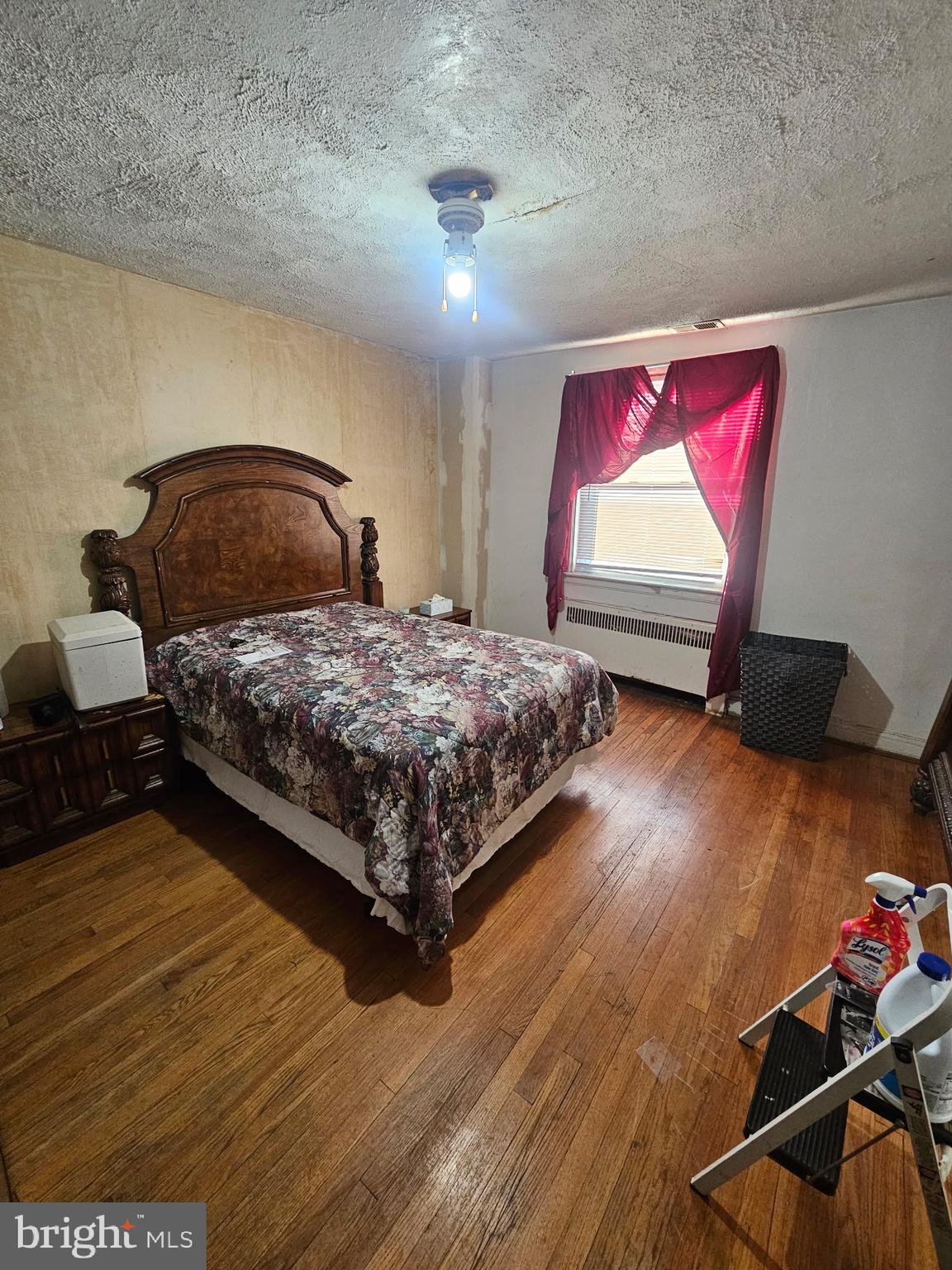 3915 Ednor Road Baltimore, MD 21218 - Photo 8 of 10 a bedroom with a bed and window