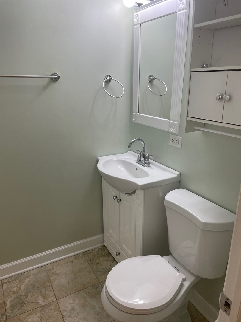 28561 West High Road Ingleside, IL 60041 - Photo 16 of 19 a white toilet sitting next to a bathroom sink