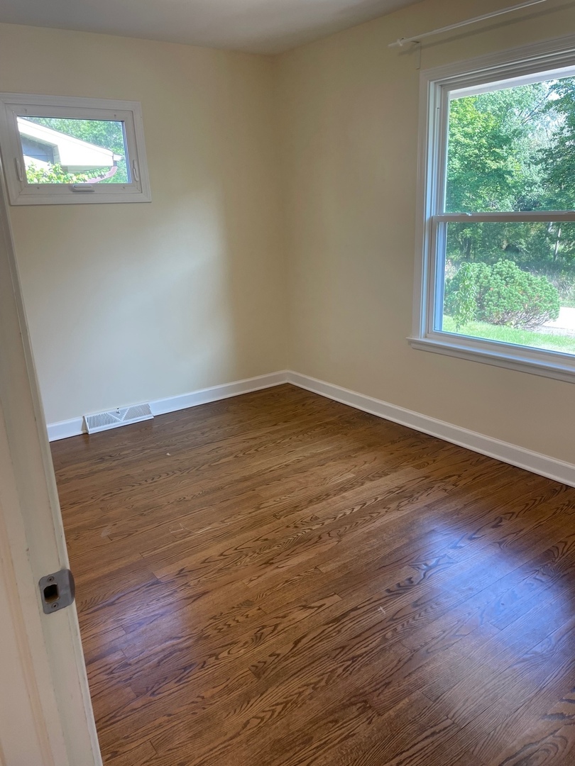 28561 West High Road Ingleside, IL 60041 - Photo 10 of 19 an empty room with wooden floor and windows