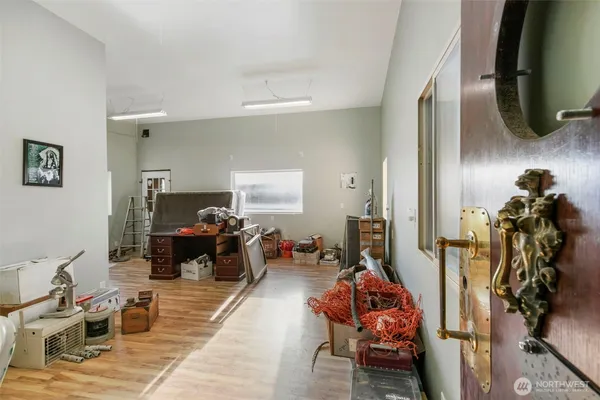 a living room with furniture a mirror and gym equipment