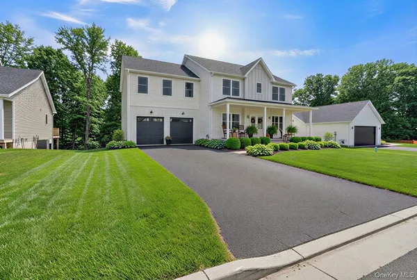 a view of house with yard and green space