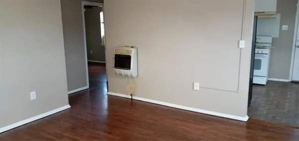 wooden floor in an empty room and a bathroom