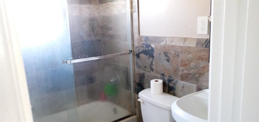 120 North Dove Road Grapevine, TX 76051 - Photo 8 of 10 a bathroom with a shower and toilet