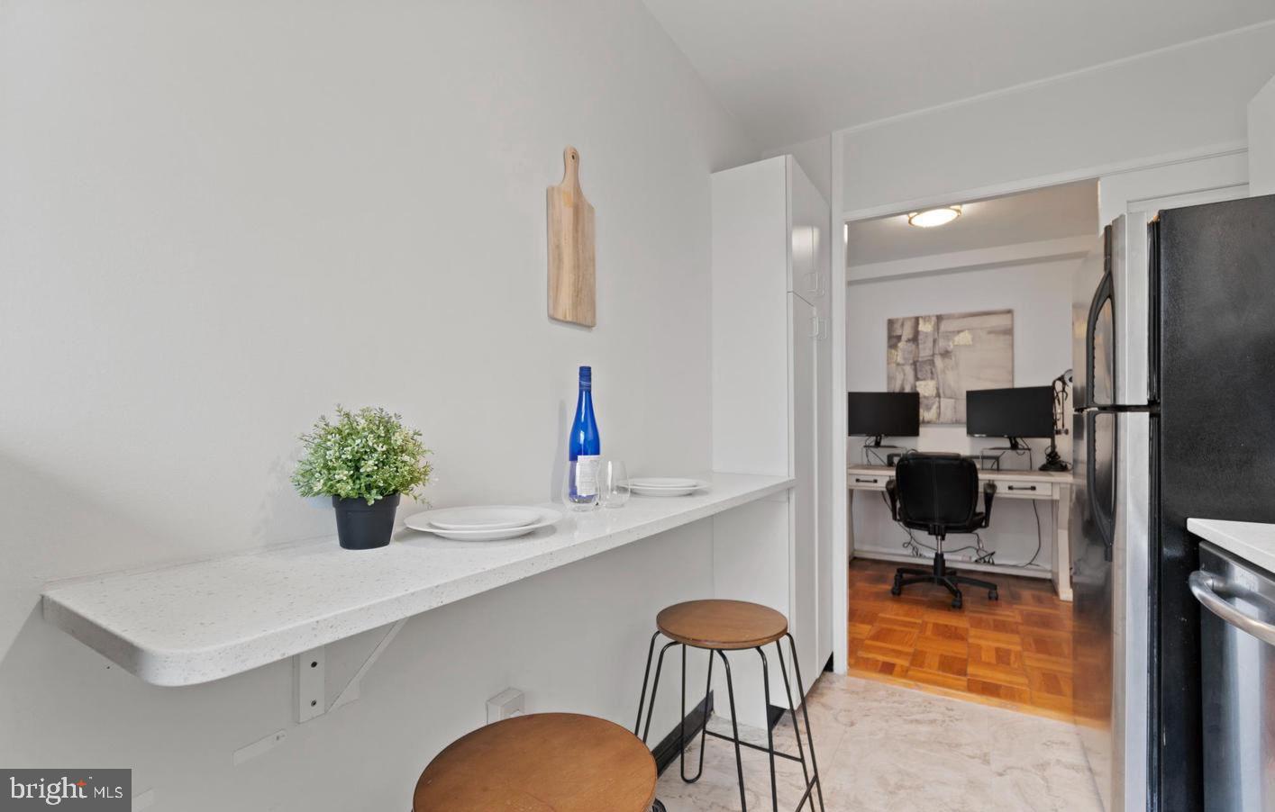 4100 W Street Northwest, Unit 410 Washington, DC 20007 - Photo 12 of 18 a kitchen with a table and chairs in it