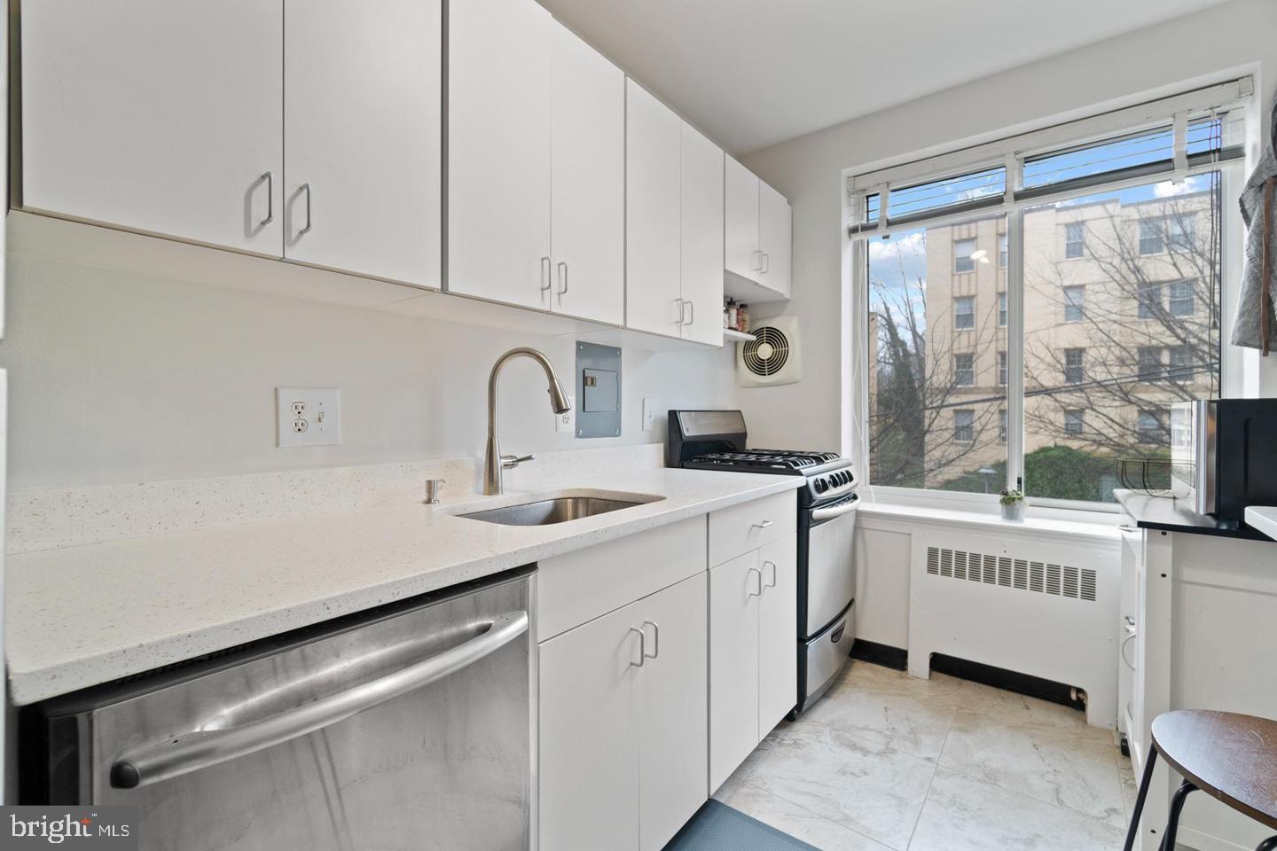 4100 W Street Northwest, Unit 410 Washington, DC 20007 - Photo 14 of 18 a kitchen with a sink and cabinets