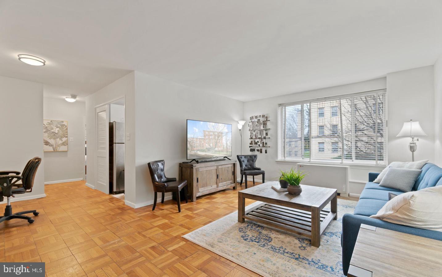 4100 W Street Northwest, Unit 410 Washington, DC 20007 - Photo 4 of 17 a living room with furniture and a table