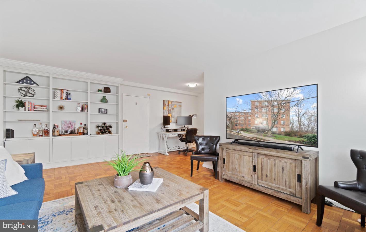 4100 W Street Northwest, Unit 410 Washington, DC 20007 - Photo 5 of 17 a living room with furniture and a flat screen tv