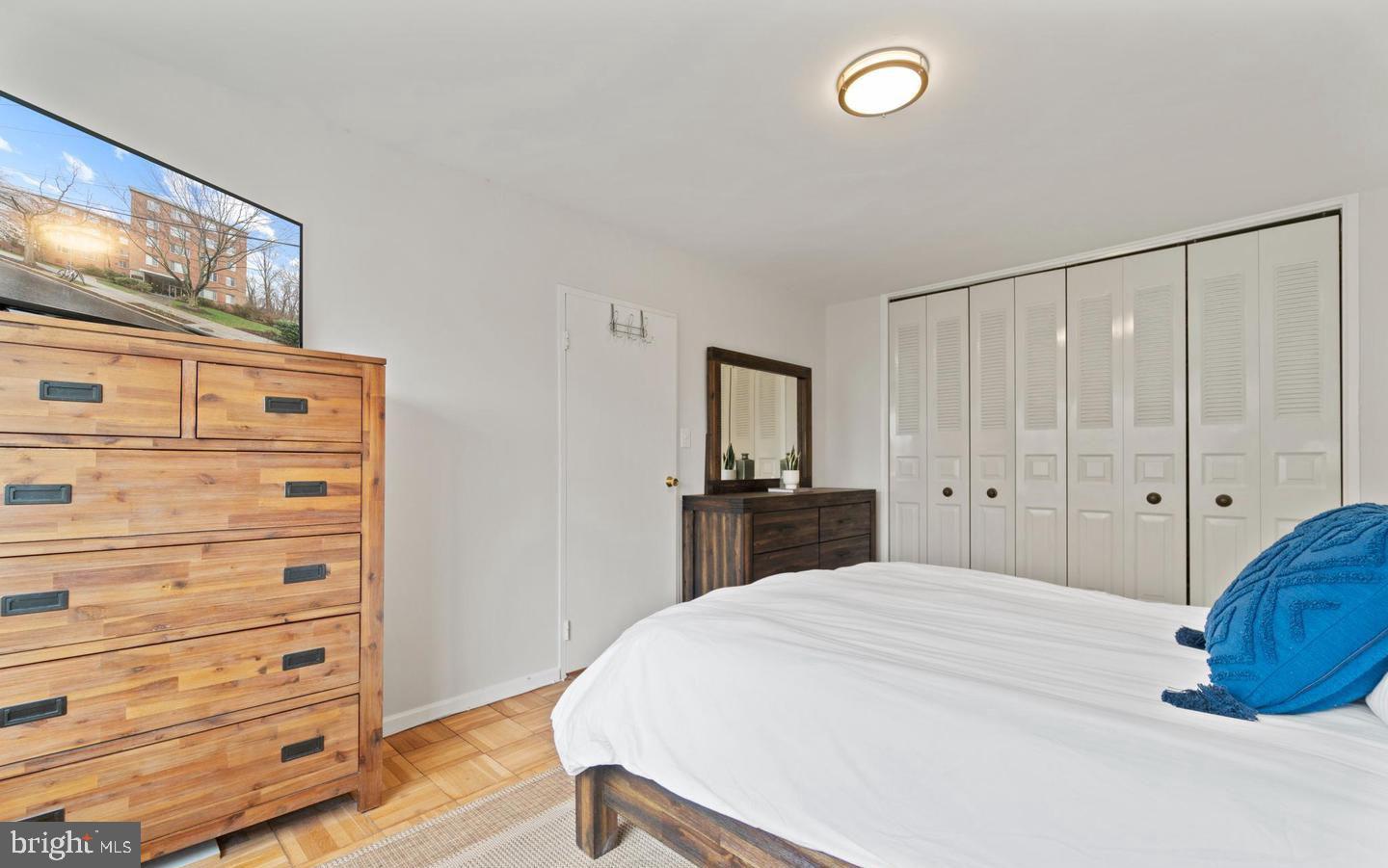 4100 W Street Northwest, Unit 410 Washington, DC 20007 - Photo 6 of 17 a bedroom with a bed and a dresser