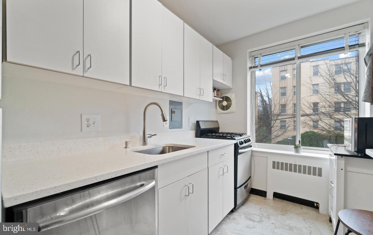 4100 W Street Northwest, Unit 410 Washington, DC 20007 - Photo 7 of 17 a kitchen with a sink and cabinets